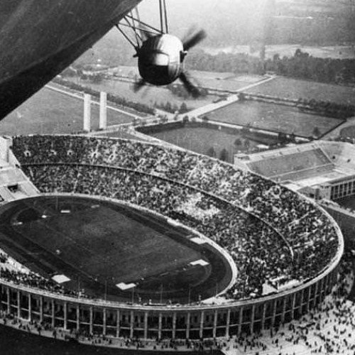 The airship Hindenburg watches over the Berlin Olympic Stadium during the 1936 Olympics