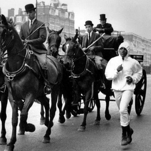 Muhammad Ali runs next to Queen Elizabeth's horse carriage, London, 1963